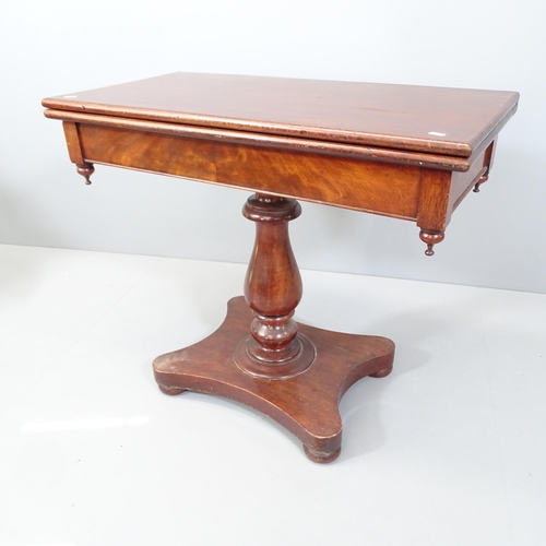 2165 - A 19th century mahogany fold-over tea table, raised on turned central column with platform base. Int... 