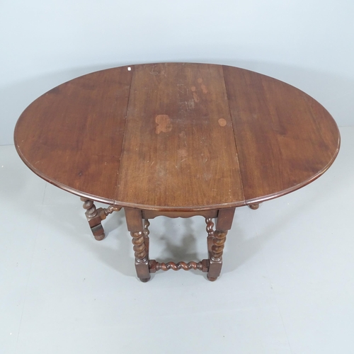 2185 - An antique oak barley-twist oval gateleg table. 91x70x44cm (extending to 136cm).