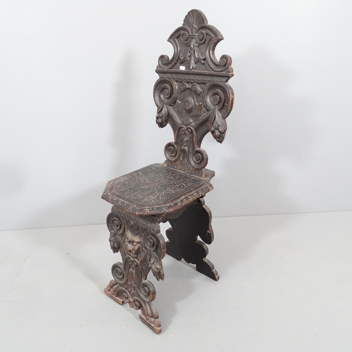 2187 - A 19th century Italian Renaissance Sgabello armorial carved oak hall chair, with green man decoratio... 