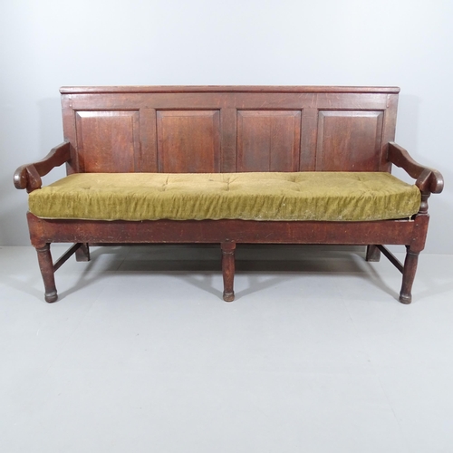 2189 - An 18th Century panelled oak settle, with upholstered cushion over slatted seat. 183x101x69cm.