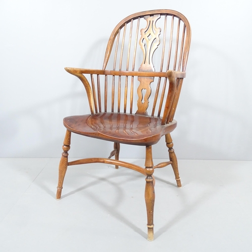 2192 - A 19th century oak and elm-seated Windsor elbow chair, with pierced splat back and crinoline stretch... 