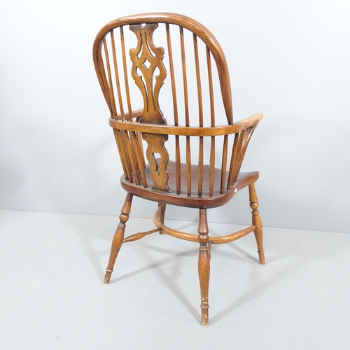 2192 - A 19th century oak and elm-seated Windsor elbow chair, with pierced splat back and crinoline stretch... 