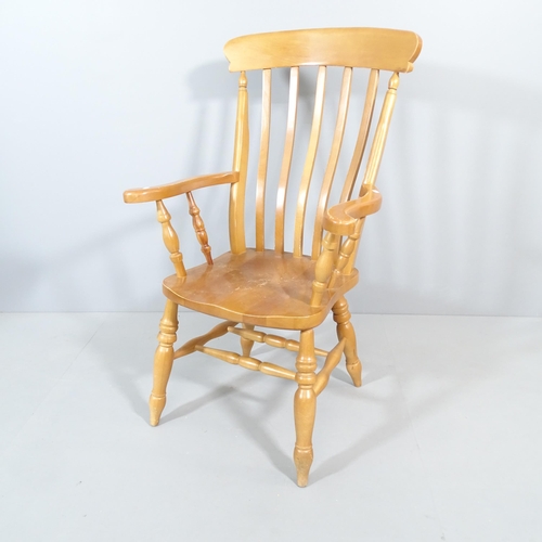 2202 - A light oak Windsor kitchen armchair.