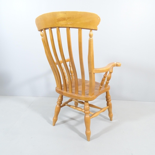 2202 - A light oak Windsor kitchen armchair.