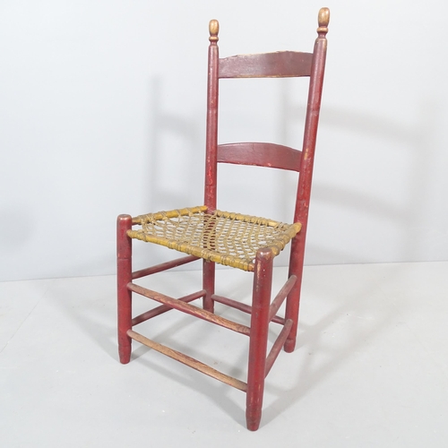 2204 - An early 19th century primitive chair with original paintwork and rawhide seat.