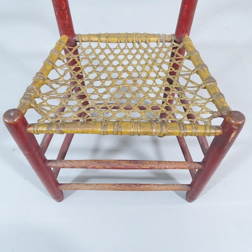 2204 - An early 19th century primitive chair with original paintwork and rawhide seat.