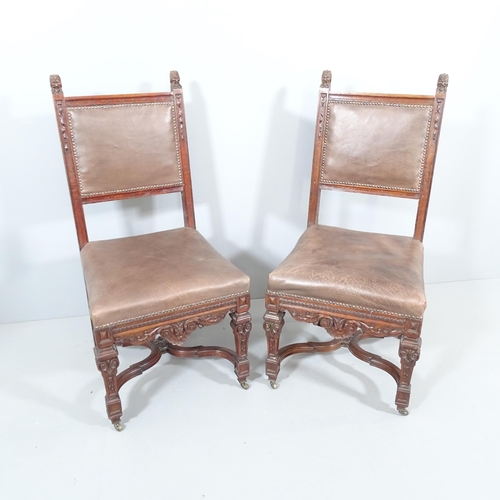 2214 - A pair of 19th century carved oak and leather upholstered Neo-Renaissance style dining chairs.