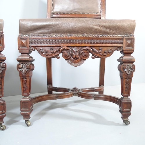 2214 - A pair of 19th century carved oak and leather upholstered Neo-Renaissance style dining chairs.