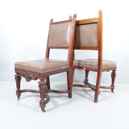 2214 - A pair of 19th century carved oak and leather upholstered Neo-Renaissance style dining chairs.