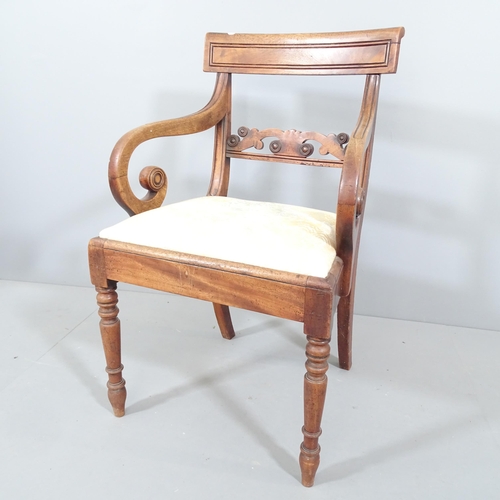 2217 - An antique Regency mahogany armchair with scrolled arms and upholstered seat.