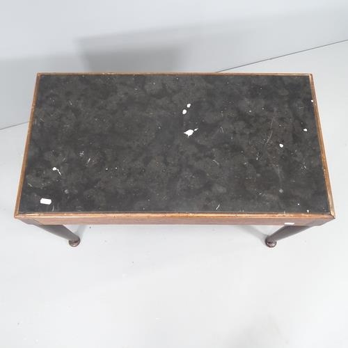 2228 - A mahogany coffee table with inset black marble top. 80x52x44cm.