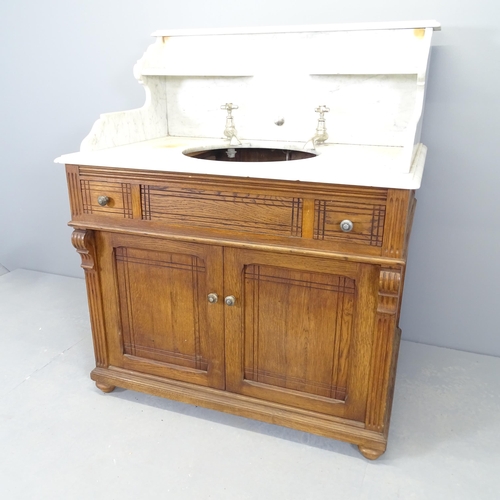 2526 - A French pitch pine and marble topped vanity cabinet, with raised back, fitted taps and cupboards un... 