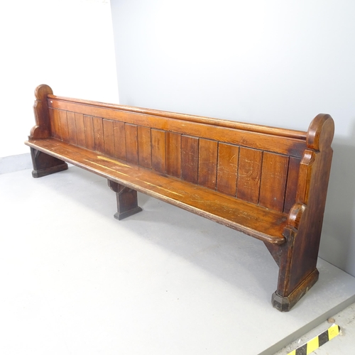 2552 - A Vintage stained pine church pew. 300x97x44cm