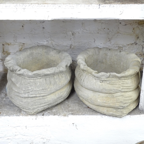 2560 - A pair of concrete sack design planters. 45x25cm.