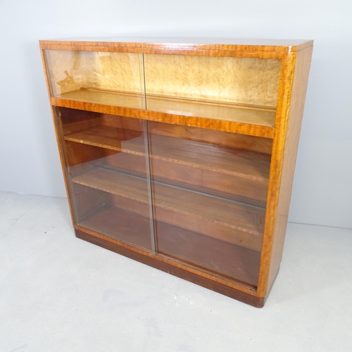 2504 - A mid-century mahogany bookcase / display cabinet with with four glass sliding doors. 123x115x31cm.