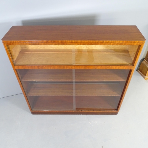 2504 - A mid-century mahogany bookcase / display cabinet with with four glass sliding doors. 123x115x31cm.