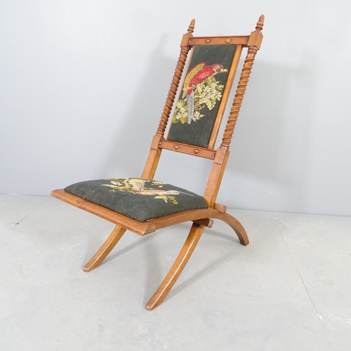 2510 - A campaign style mahogany folding chair with upholstered seat and back panel.