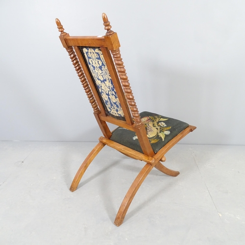 2510 - A campaign style mahogany folding chair with upholstered seat and back panel.