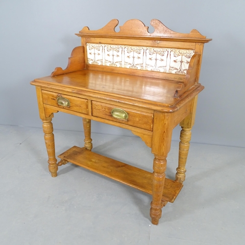 2513 - A Victorian pine two-tier wash stand, with raised tiled back, two frieze drawers and raised on turne... 