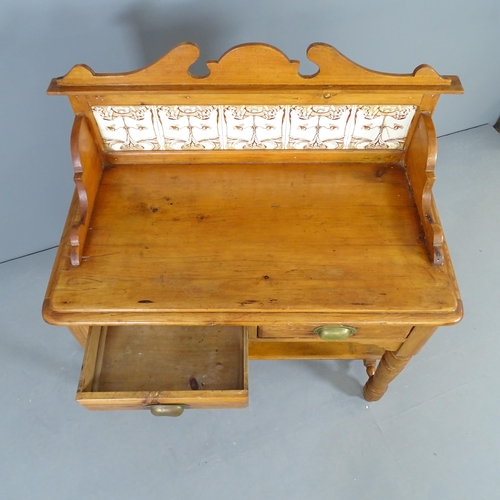 2513 - A Victorian pine two-tier wash stand, with raised tiled back, two frieze drawers and raised on turne... 