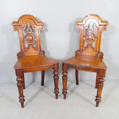 2515 - A pair of antique oak hall chairs, with carved and pierced decoration.