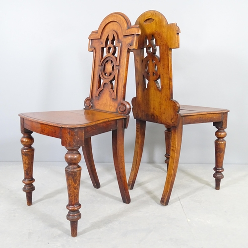 2515 - A pair of antique oak hall chairs, with carved and pierced decoration.