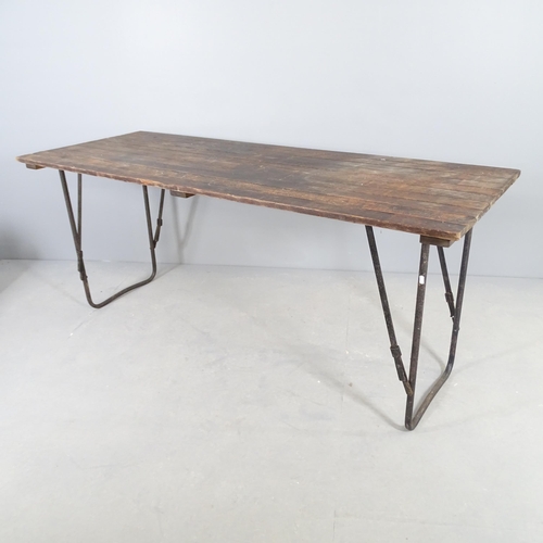 2521 - A stained teak plank top trestle table with folding metal base. 182x77x68cm.