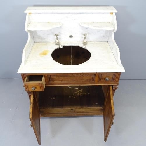 2526 - A French pitch pine and marble topped vanity cabinet, with raised back, fitted taps and cupboards un... 