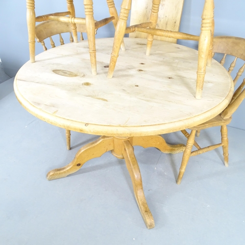 2537 - A circular pine draw-leaf kitchen table, 120 (ending to 160cm) x 76cm, with one spare leaf and four ... 