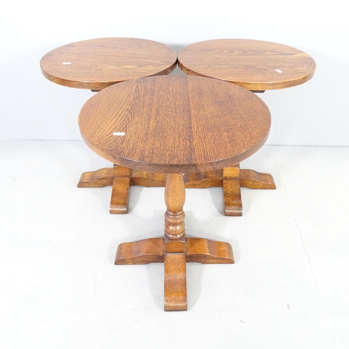 2540 - A set of three oak circular lamp / occasional tables. 46x57cm.