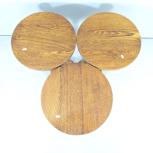 2540 - A set of three oak circular lamp / occasional tables. 46x57cm.