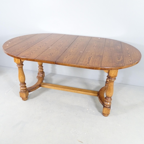 2541 - A modern oak Gillow's style draw-leaf dining table, with two spare leaves, on turned legs with H-sha... 