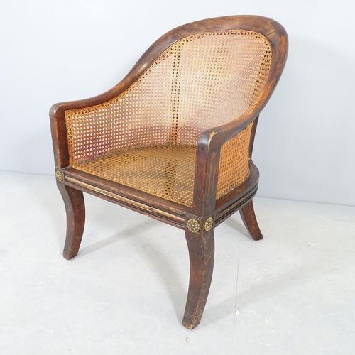 2545 - A 1930s bergere tup chair, with cane panels and oak frame.