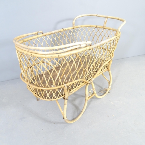 2550 - A vintage two-section wicker plant stand / storage basket in the form of a pram. 90x72x56cm.