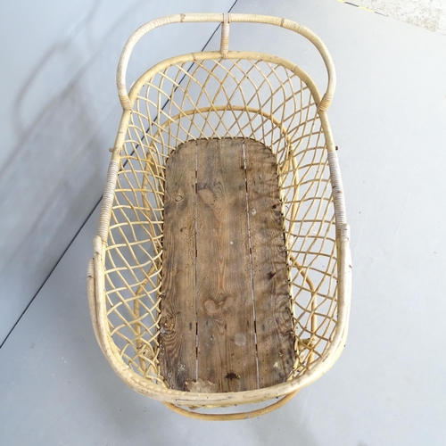 2550 - A vintage two-section wicker plant stand / storage basket in the form of a pram. 90x72x56cm.