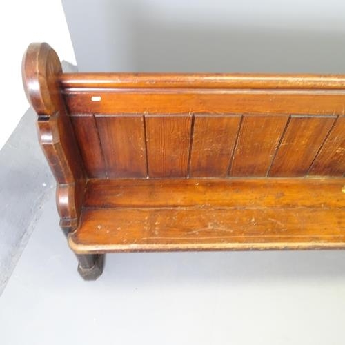 2552 - A Vintage stained pine church pew. 300x97x44cm