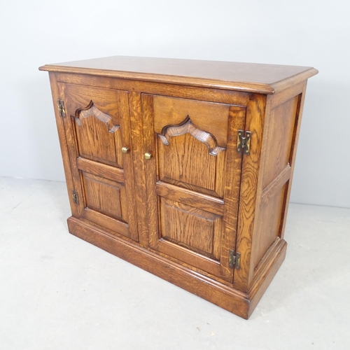 2554 - A reproduction oak two-door cabinet, with fielded panels and  shelf fitted interior. 92x77x41cm.