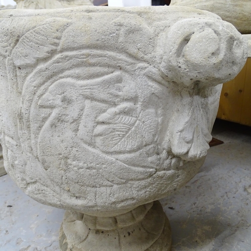 2562 - A pair of modern concrete two-section garden urns with stag and bird decoration. 48x46x38cm.