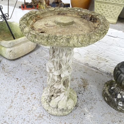 2587 - A weathered concrete two-section bird bath on tree trunk design base. 48x70cm.