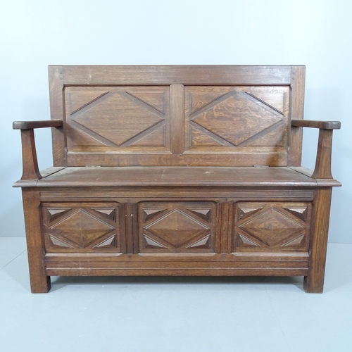 2235 - An early 20th century panelled oak hall bench, with lifting seat. 124x78x44cm.