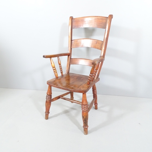 2249 - A stained pine Windsor kitchen armchair.