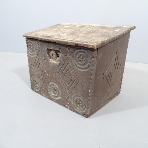 2275 - An 18th century oak casket, with allover carved decoration. 38x32x30cm.