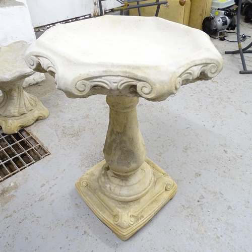 2568 - A modern concrete two-section bird bath with scrolled decoration. 52x66cm.