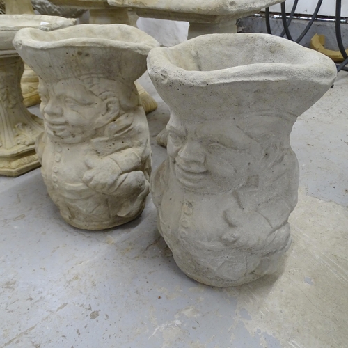 2572 - A pair of concrete planter/umbrella stands in the form of toby jugs. 30x43cm