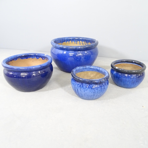 2579 - Four blue glazed terracotta garden planters. Largest 45x28cm.