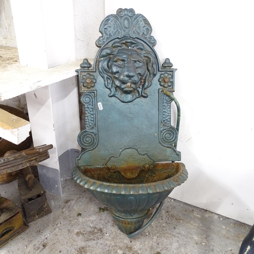 2583 - A painted cast iron lion mounted water feature. 42x78x20cm.