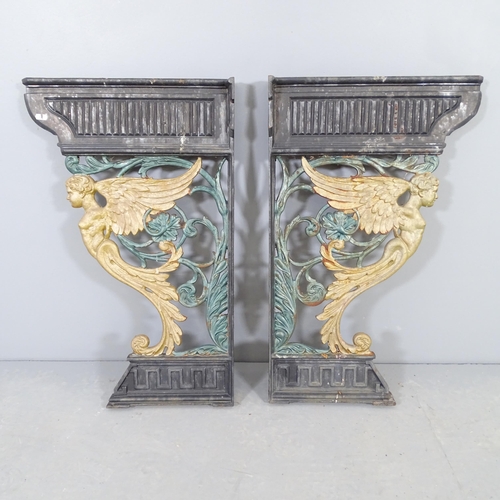 2588 - A pair of painted cast iron brackets with angel design. 48x78cm.