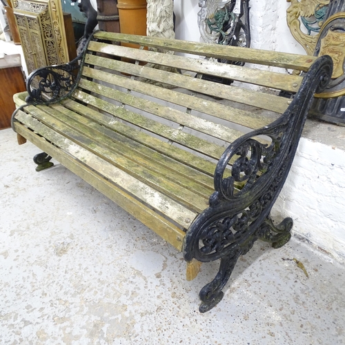 2594 - A weathered teak slatted garden bench with wrought iron ends inscribed G.R V 1930. 158x86x85cm.