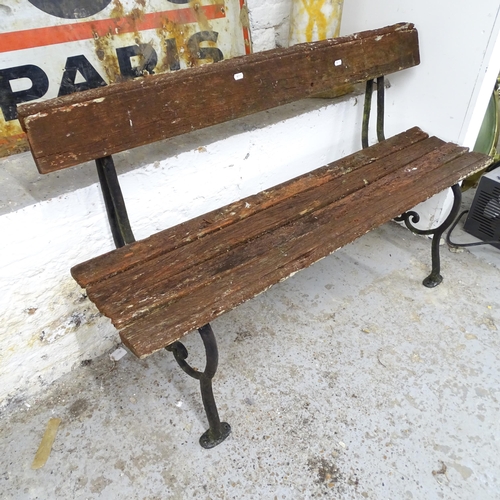 2599 - A weathered teak garden bench on wrought iron frame. 122x74x41cm.