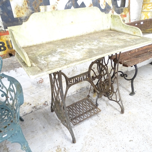 2601 - A marble topped garden table on iron Singer sewing machine base. 100x97x50cm.